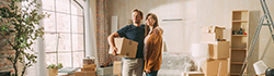 Couple unpacking boxes in a living room